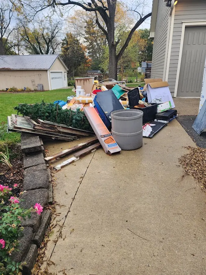 Dumpster being loaded with debris for 3 Yard Dumpster Rental in Thompson's Station